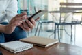 A woman`s hands holding , using and texting message from smart phone in cafe Royalty Free Stock Photo