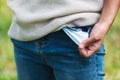 A woman showing no money by turning out an empty jean pocket Royalty Free Stock Photo