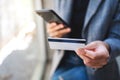 A woman using credit card for purchasing and shopping online on mobile phone Royalty Free Stock Photo