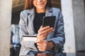 A woman using credit card for purchasing and shopping online on mobile phone Royalty Free Stock Photo