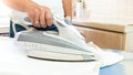 Closeup image of woman using electric iron at laundry Royalty Free Stock Photo