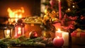 Closeup image of wooden table decorated for Christmas against burning fireplace at living room Royalty Free Stock Photo