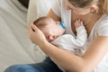 Closeup photo of young mother caressing her sleeping baby boy Royalty Free Stock Photo