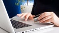 Closeup photo of young woman doing onkine shopping and holding credit card Royalty Free Stock Photo