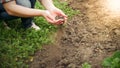 Closeup image of young woman holding dry earth or soil in hands at garden Royalty Free Stock Photo