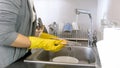 Closeup photo of young woman washing dishes Royalty Free Stock Photo