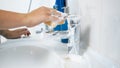 Closeup photo of young woman washing water tap with sponge Royalty Free Stock Photo