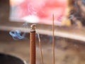 Incenses and smoke in a giant golden burner at Chinese temple.