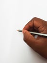 Indian Man writing using Pencil in a hand on white paper Royalty Free Stock Photo