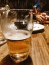 Closeup of an Indian Pale Ale beer on a wooden table under the lights Royalty Free Stock Photo