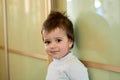 Closeup indoor portrait of a baby boy with naughty hair. The various emotions of a child.