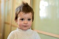 Closeup indoor portrait of a baby boy with naughty hair. The various emotions of a child.