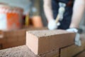Closeup of industrial bricklayer laying bricks at construction site