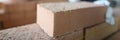 Closeup of industrial bricklayer laying bricks at construction site