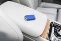 Closeup inside vehicle of wireless blue leather key ignition on natural wood panel. Wireless start engine key. Car key remote isol Royalty Free Stock Photo