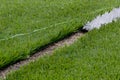 Closeup installation of football field with artificial turf with grass. Close up of line of an artificial football field. Details