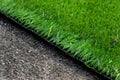 Closeup installation of football field with artificial turf with grass. Close up of line of an artificial football field. Details