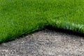 Closeup installation of football field with artificial turf with grass. Close up of line of an artificial football field. Details