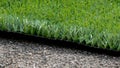 Closeup installation of football field with artificial turf with grass. Close up of line of an artificial football field. Details