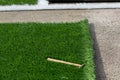 Closeup installation of football field with artificial turf with grass. Close up of line of an artificial football field. Details