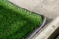 Closeup installation of football field with artificial turf with grass. Close up of line of an artificial football field. Details