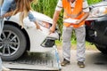 Closeup insurance company officers post a list of repairs on work list clipboard according sufferer woman point out the damage on