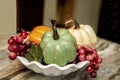 Closeup of Interior Kitchen counter with three Faux Decorative Pumpkins with grapes in bowl
