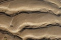 Flow patterns on a wet sand beach. Abstract background Royalty Free Stock Photo