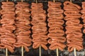 Closeup of Isaw or chicken intestine on sticks laid on the grill. Isaw is a Filipino delicacy