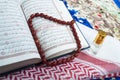 closeup of Islamic book Quran rosary and shemagh scent bottle on colorful prayer mat,religious Royalty Free Stock Photo