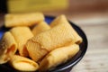 Closeup of isolated french small mini baked cheese crepe rolls petite crepes fourrees with cheese filling on wood table