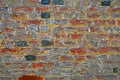 Closeup of isolated old medieval brick stone wall with faded pale washed out red grey colors