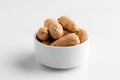 Closeup on isolated peanut nuts in a bowl
