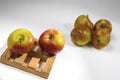 Closeup isolated small apples on wooden pallet