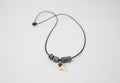 Closeup and isolated view of a shark tooth necklace with string Royalty Free Stock Photo