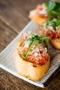 Italian bruschetta tomatoes parmesan arugula Royalty Free Stock Photo