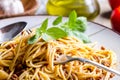 Closeup of italian spaghetti bolognese with basil in fork. Traditional homemade mediterranean food recipe