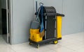 Closeup of janitorial. yellow mop bucket and set of cleaning equipment at the airport Royalty Free Stock Photo