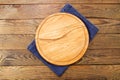 Closeup jeans tablecloth on wooden background. table cloth, round pizza cutting board on brown wood textured tabletop. Mock up,