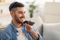 Closeup of jewish guy using voice assistant on cellphone Royalty Free Stock Photo