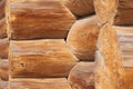 Closeup of joint of cracked logs and transect of round logs with coils and cracks at the corner of old wooden building Royalty Free Stock Photo