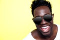 Closeup of joyful young african guy in sunglasses Royalty Free Stock Photo