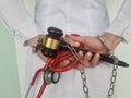 Closeup of judge gavel of stethoscope doctor in hands of doctor