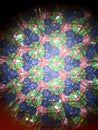 Closeup of a Kaleidoscope Pattern in Green, Blue, Pink and Yellow, Repetitive Geometric, Triangular Optical Illusion, Mirrors