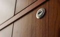 Closeup of a key hole on a drawer door with wooden texture Royalty Free Stock Photo