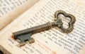 Closeup of key placed on vintage bible