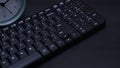 closeup keyboard and clock on black flat background