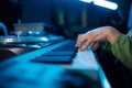 Closeup of keyboardist musician in neon light recording studio Royalty Free Stock Photo