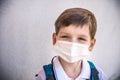 Closeup Kid face wearing protective face mask for pollution or virus, Cropped shot of school boy wearing protection mask against Royalty Free Stock Photo