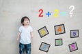 Closeup asian kid look at mathematic question on marble stone wall textured background